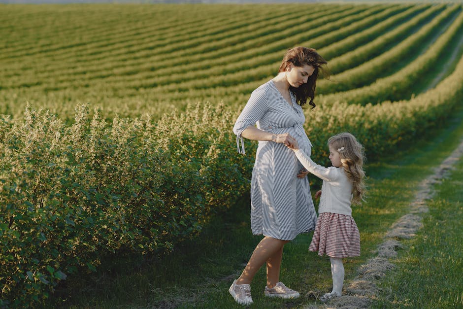 Mother and daughter bonding in a lush agricultural field, symbolizing new beginnings and family love.